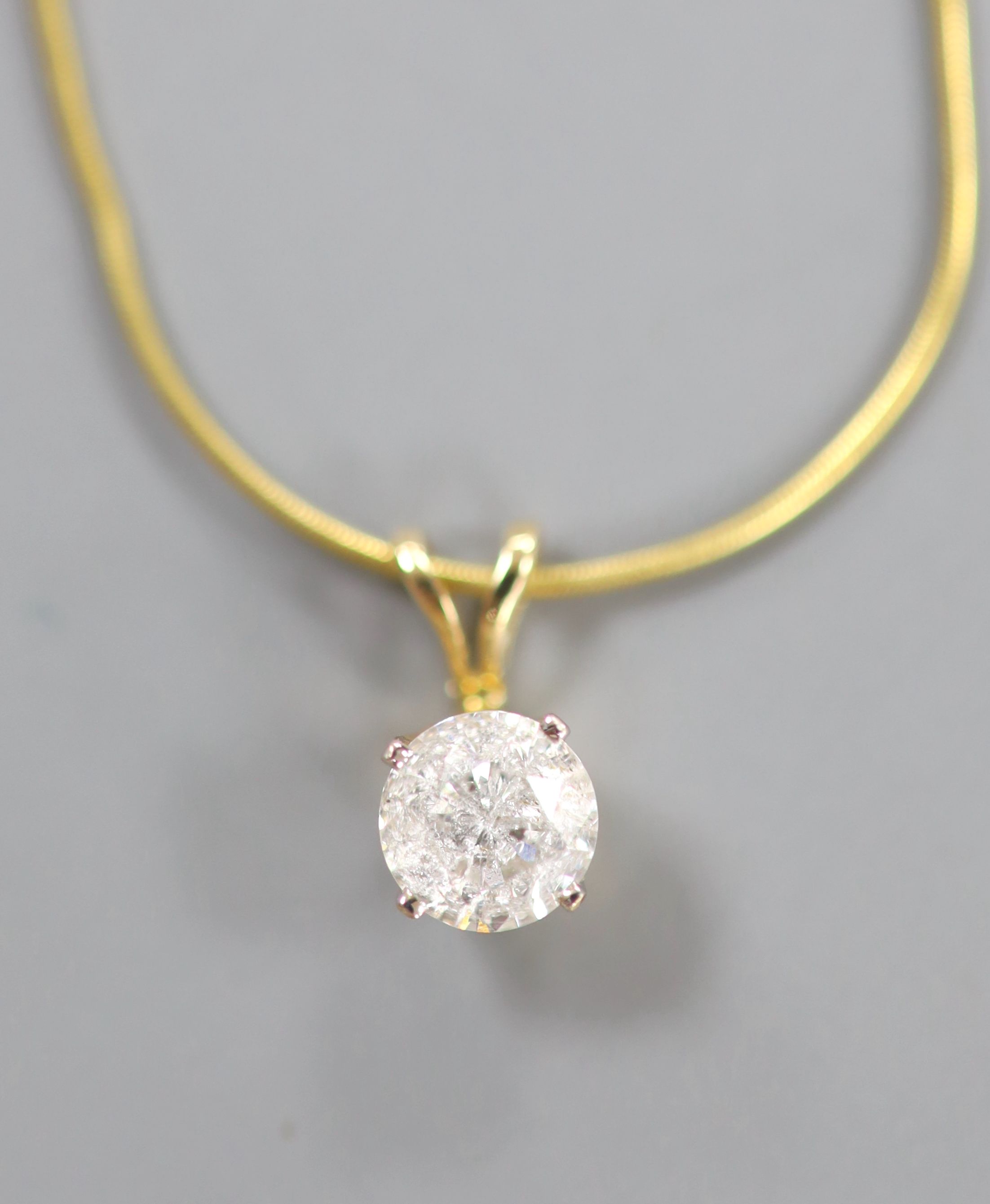 A solitaire diamond pendant on 9ct gold fine chain
